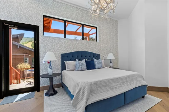 a view of a hallway with wooden floor and entryway