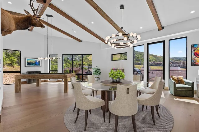 a view of a dining room with furniture wooden floor and chandelier