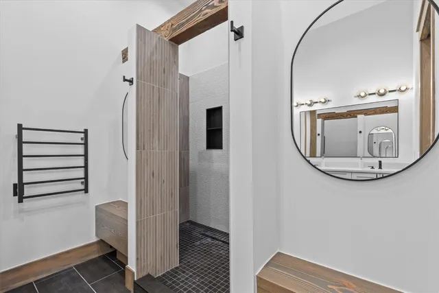 a spacious bedroom with a bed and a flat screen tv