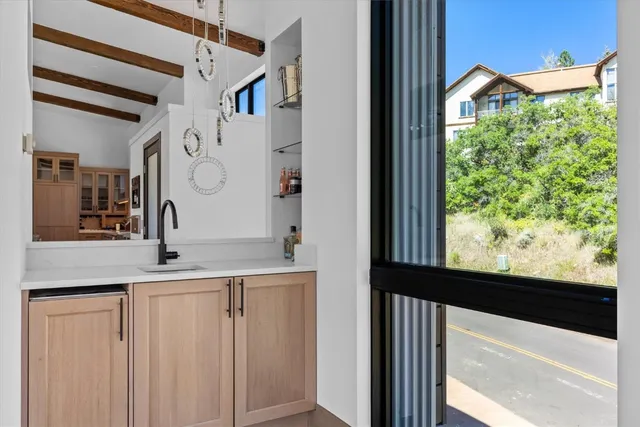 a bathroom with a granite countertop sink and a large mirror