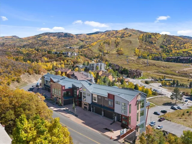 an aerial view of residential houses with outdoor space