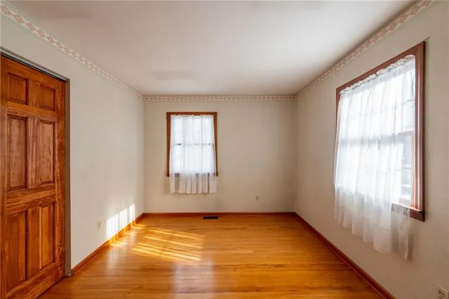 a bathroom with a granite countertop sink vanity mirror and toilet