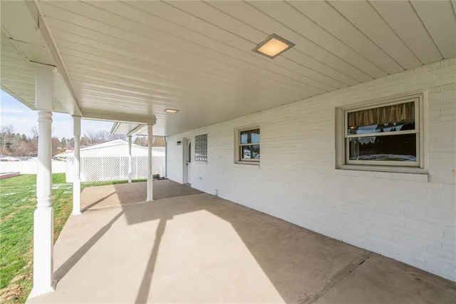 a aerial view of a house with a big yard plants and large trees