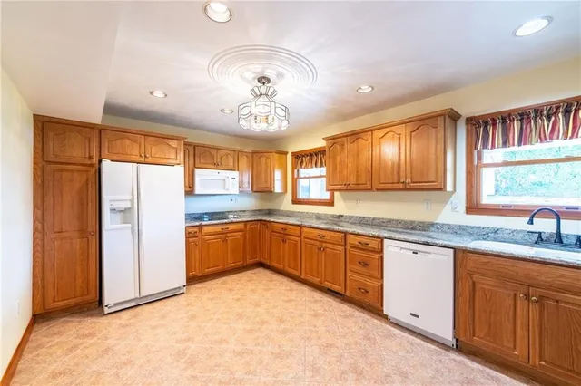 a large kitchen with cabinets wooden floor and stainless steel appliances