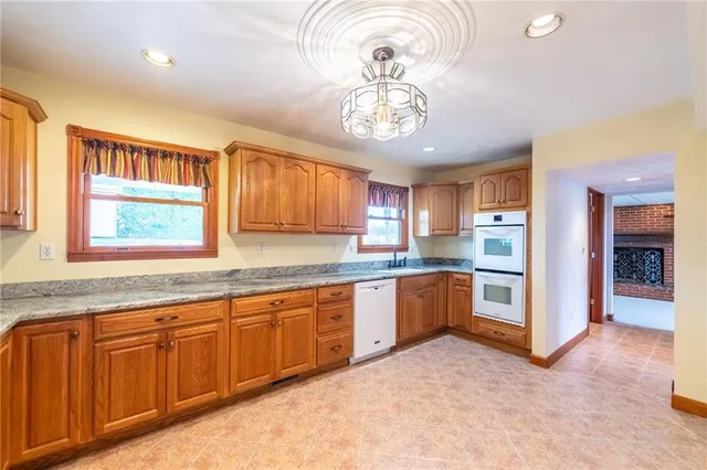 a large kitchen with a large window and cabinets