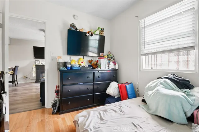 a bedroom with a bed and flat screen tv