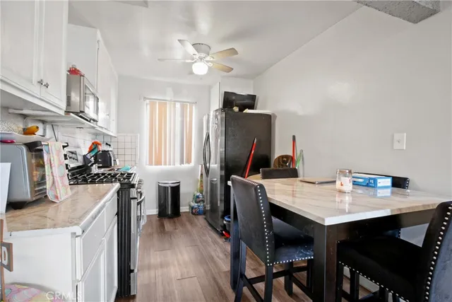 a room with a table chairs and wooden floor