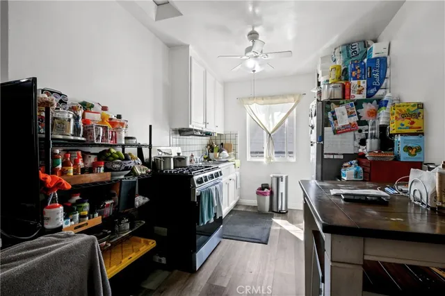 a living room with lots of furniture and clothes
