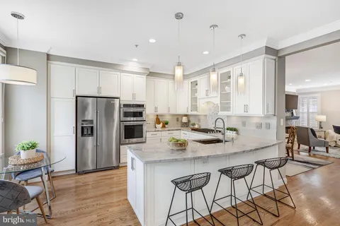 a kitchen with granite countertop a center island stainless steel appliances cabinets and a counter top space