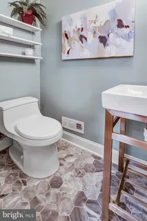 a white toilet sitting next to a bathroom sink