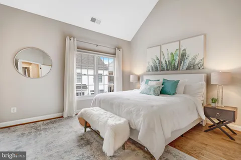 a spacious bedroom with a bed and a window