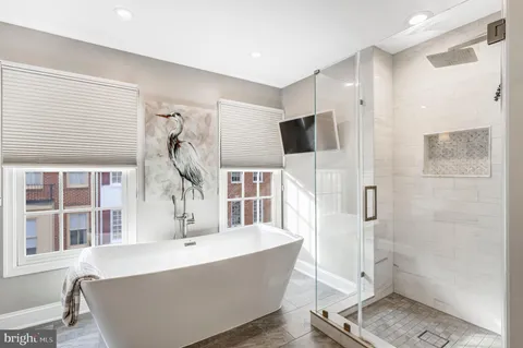 a living room with a large window and a wooden floor