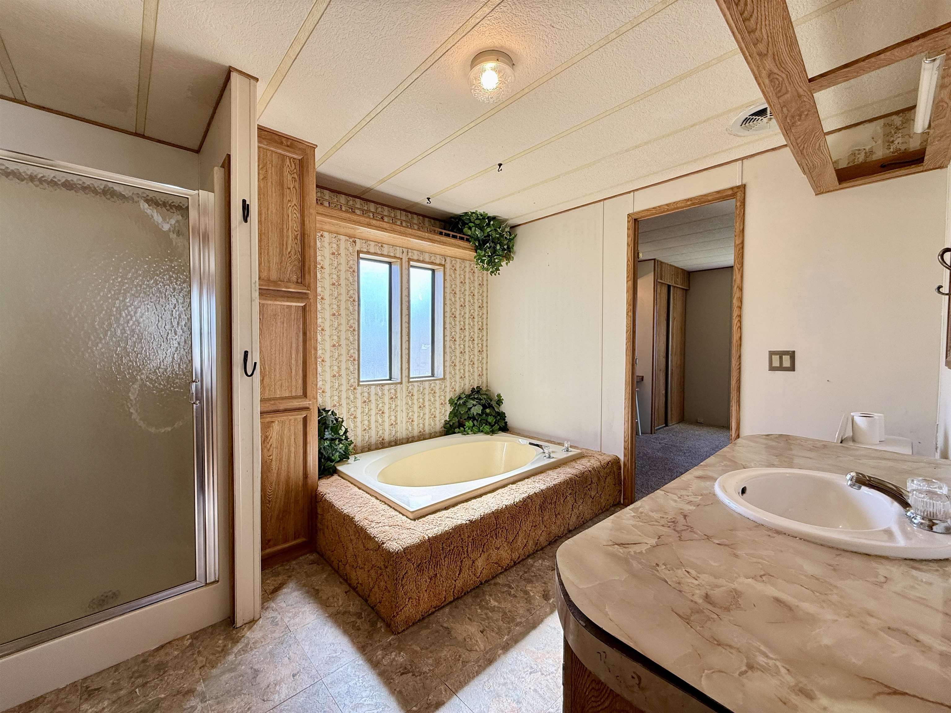 3251 E Road, Unit 33 Clifton, CO 81520 - Photo 17 of 28 a spacious bathroom with a tub sink and mirror