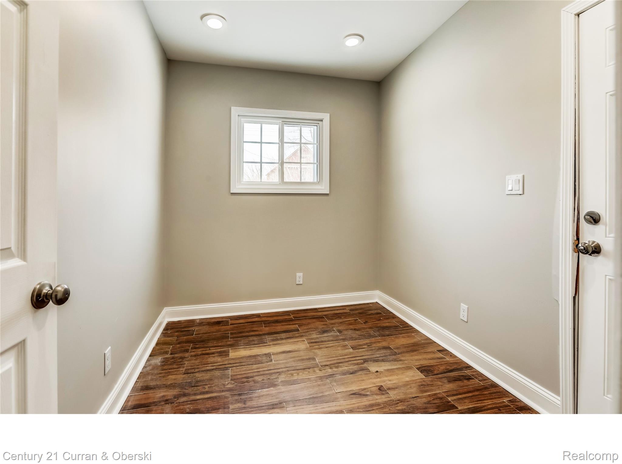641 Josephine Street Detroit, MI 48202 - Photo 7 of 11 Neutral wall paint paired with rich wood-finish flooring