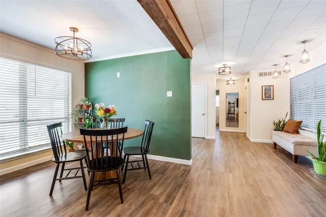 a kitchen with stainless steel appliances granite countertop a lot of counter space and wooden floors