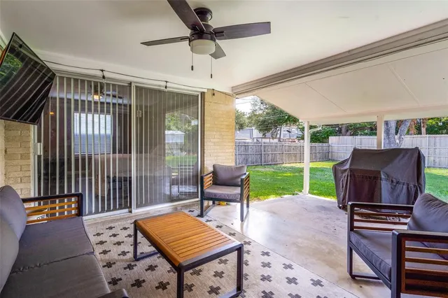 a view of a workspace with furniture and window