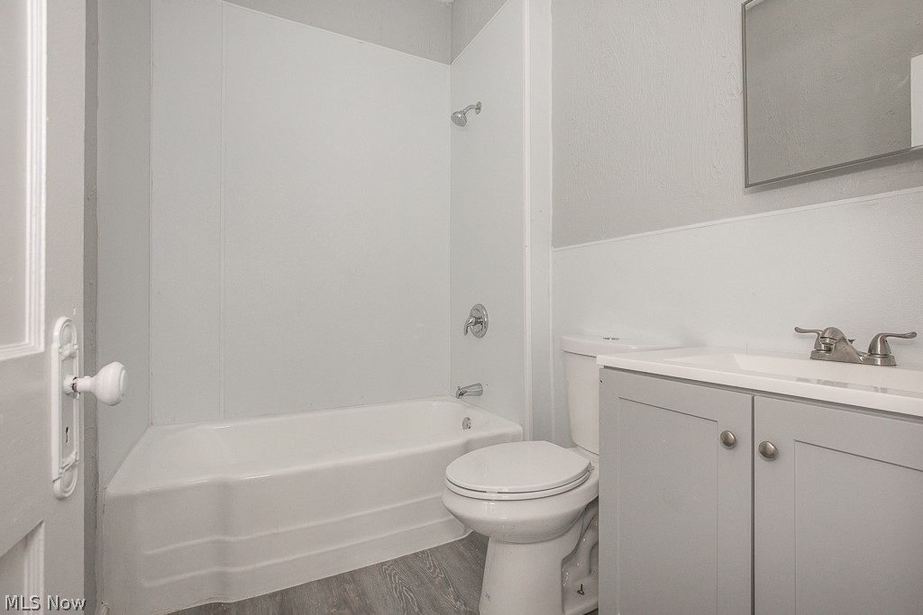 1000 Eddy Road Cleveland, OH 44108 - Photo 30 of 38 Bathroom with vanity, dark wood finished floors, and tub / shower combination