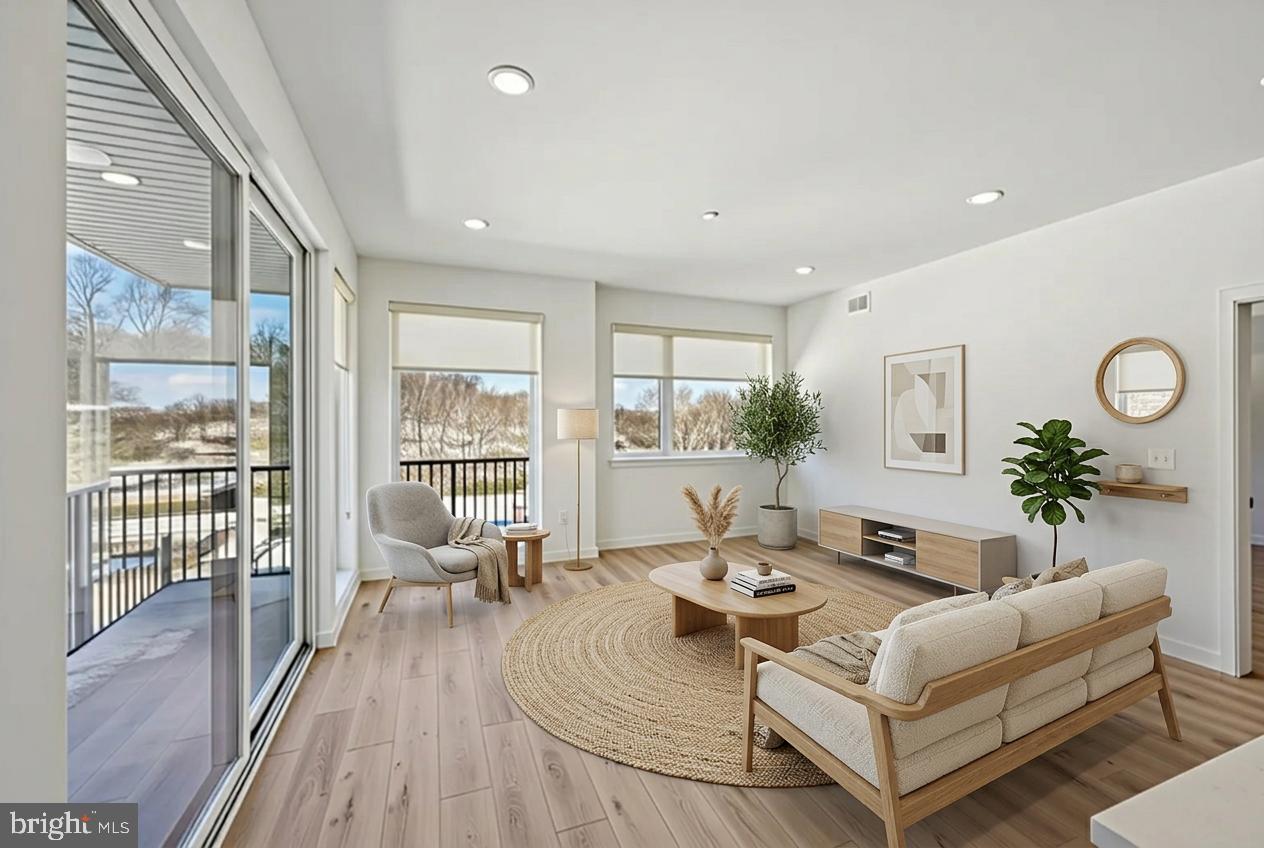 23 Rock Hill Road, Unit 210 Bala Cynwyd, PA 19004 - Photo 1 of 7 a living room with furniture wooden floor and a large window