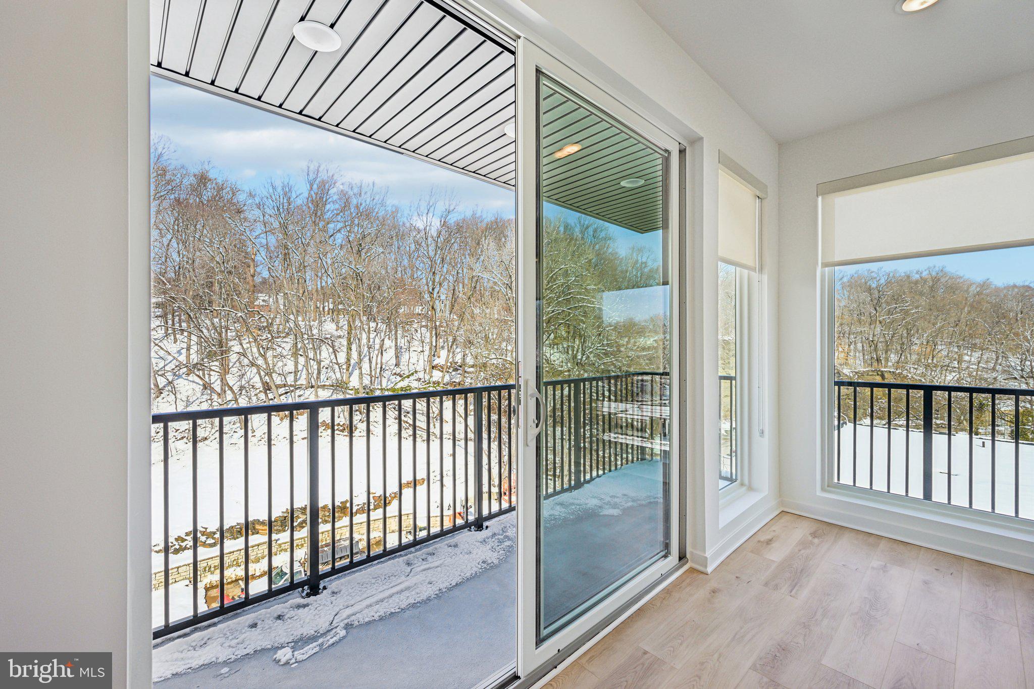 23 Rock Hill Road, Unit 210 Bala Cynwyd, PA 19004 - Photo 2 of 7 a view of a room with wooden floor and windows
