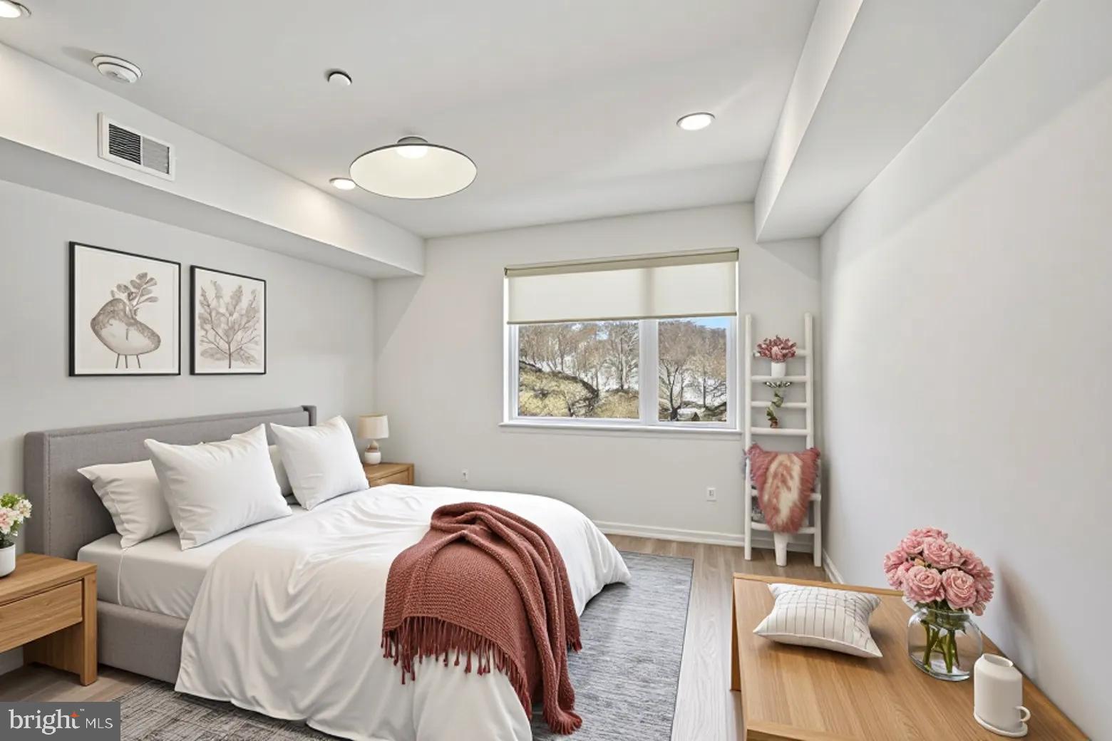 23 Rock Hill Road, Unit 210 Bala Cynwyd, PA 19004 - Photo 3 of 7 a bedroom with a bed and a window