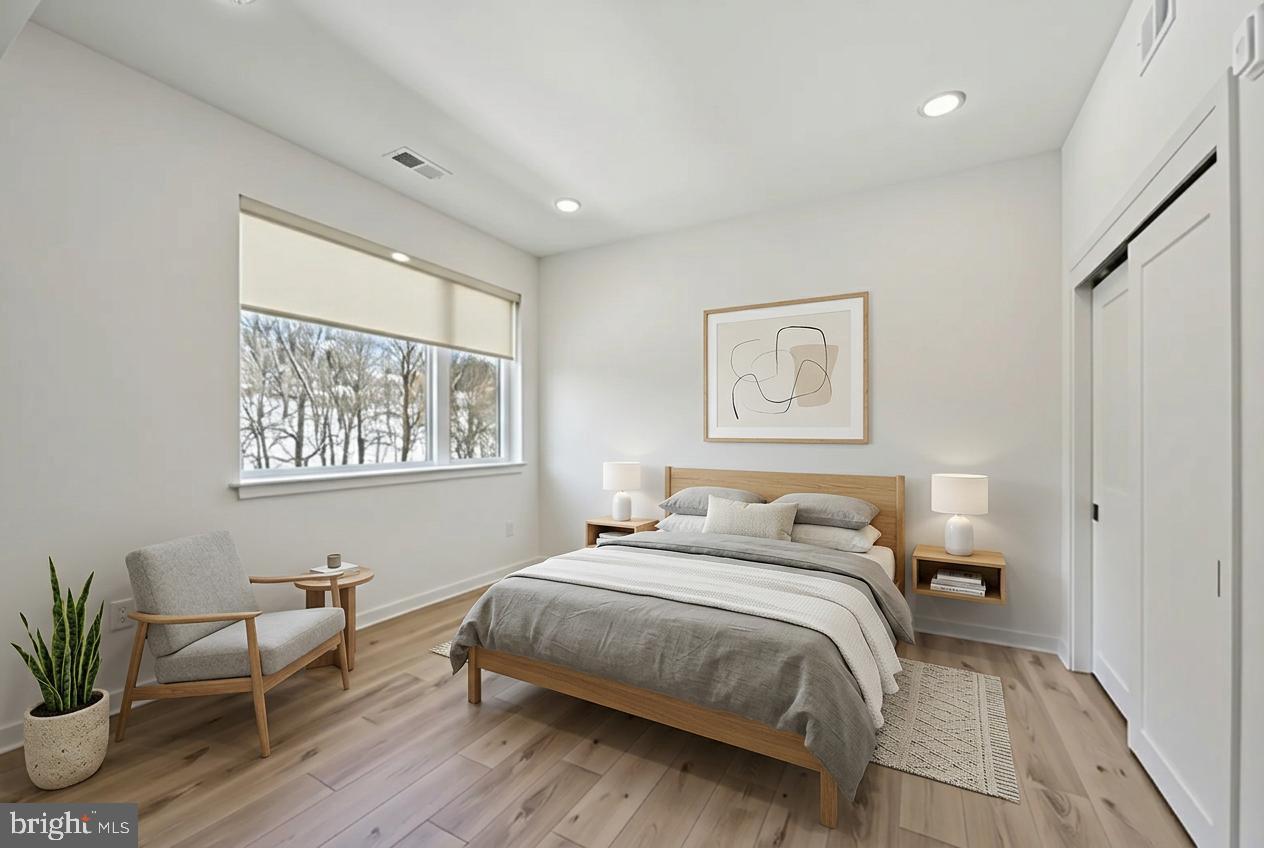 23 Rock Hill Road, Unit 210 Bala Cynwyd, PA 19004 - Photo 4 of 7 a bedroom with a bed and a window