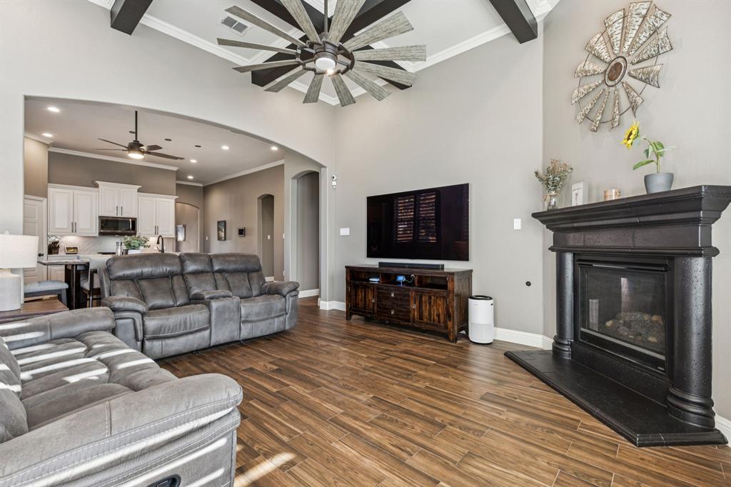 2925 Inn Kitchen Way McKinney, TX 75071 - Photo 12 of 40 a living room with furniture a flat screen tv and a fireplace