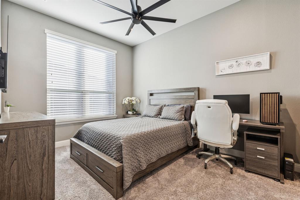 2925 Inn Kitchen Way McKinney, TX 75071 - Photo 18 of 40 a bedroom with a bed and dresser with wooden floor