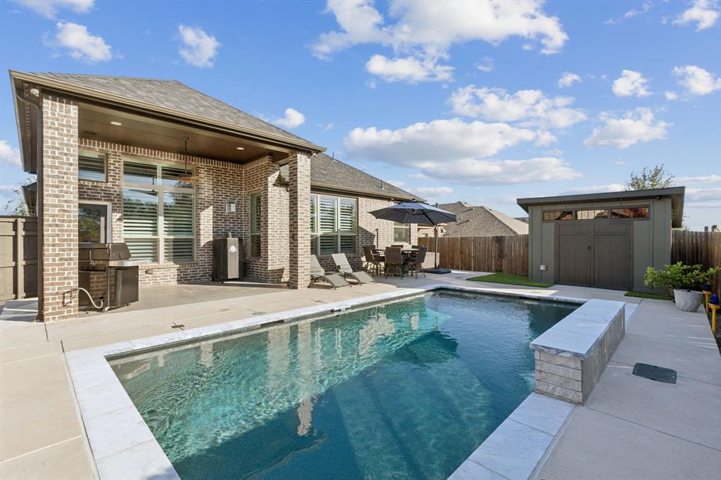 2925 Inn Kitchen Way McKinney, TX 75071 - Photo 28 of 40 a view of a patio with table and chairs with plants and wooden fence