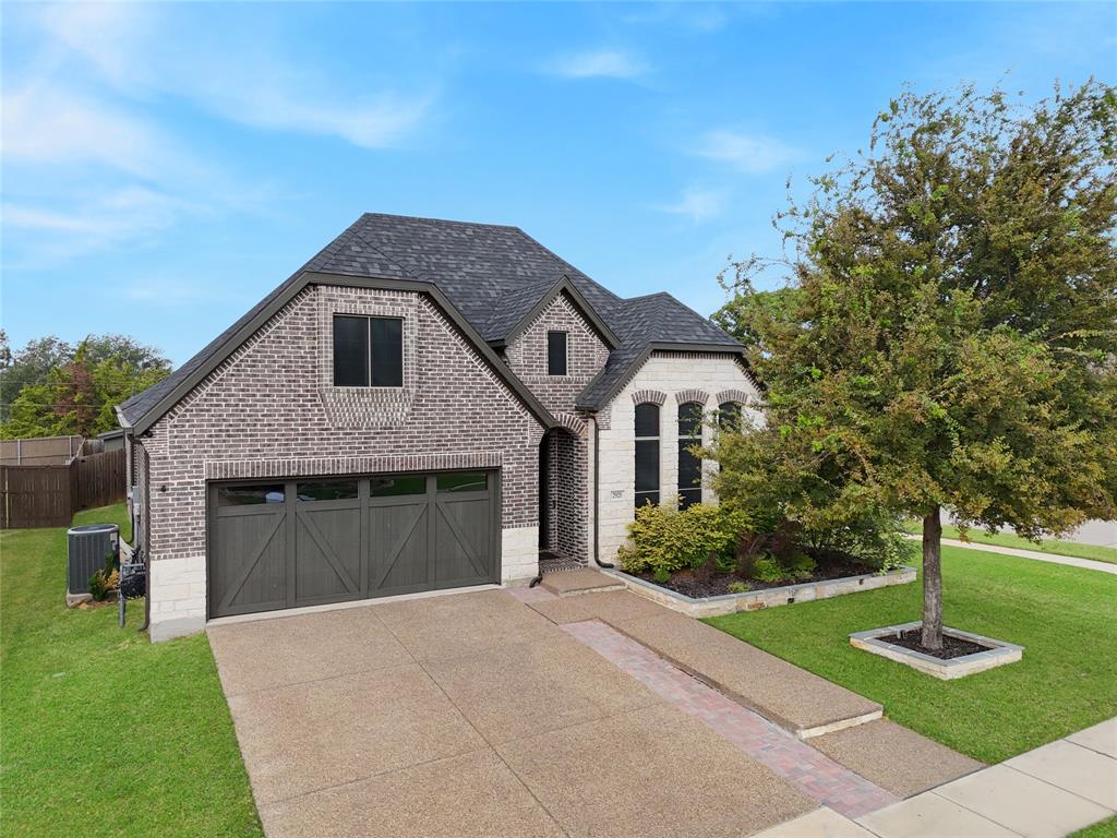 2925 Inn Kitchen Way McKinney, TX 75071 - Photo 31 of 40 a front view of a house with garage and yard