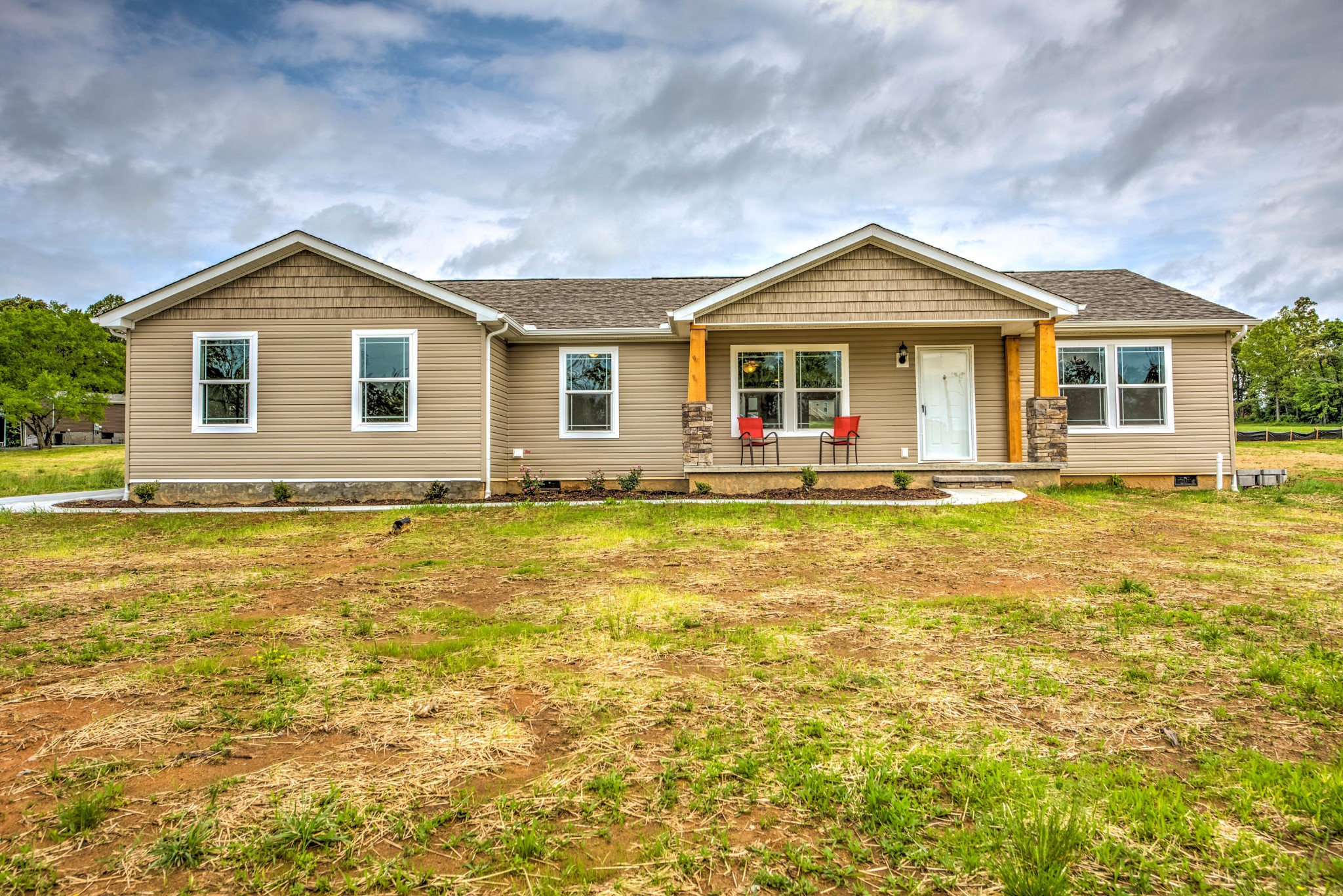 a front view of house with yard and green space