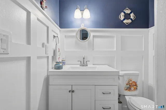a bathroom with a sink vanity and a mirror