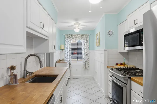 a kitchen with a sink a stove and cabinets