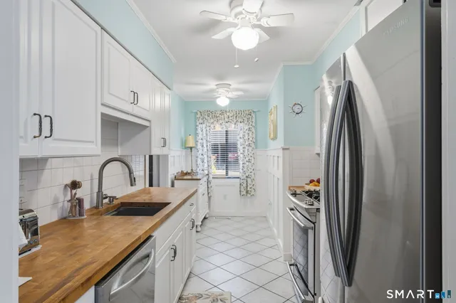 a kitchen with a refrigerator and a sink