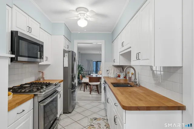 a kitchen with sink stove and cabinets