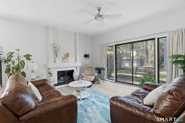 a living room with furniture and a floor to ceiling window