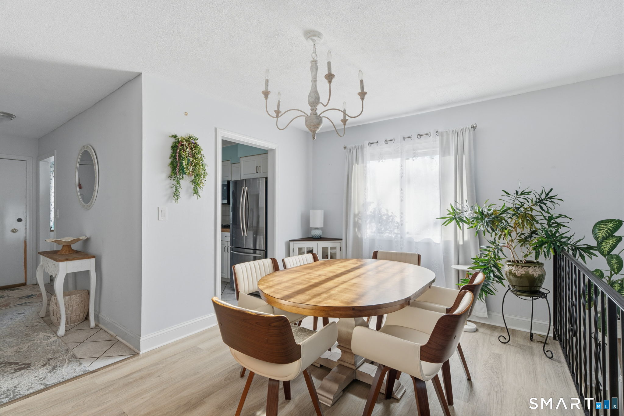 1 Coach Drive, Unit 1 Southington, CT 06489 - Photo 9 of 39 a dining room with furniture potted plants and wooden floor