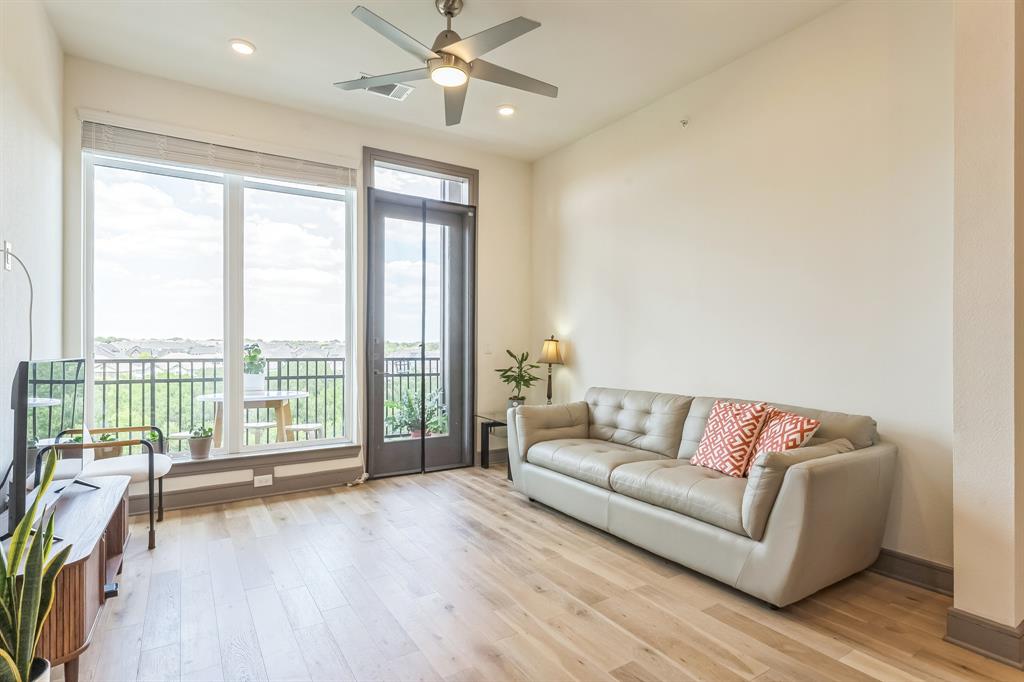 2700 Old Denton Road, Unit 4424 Carrollton, TX 75007 - Photo 6 of 12 a living room with furniture and a large window