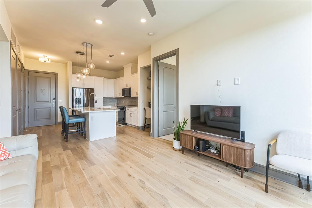 2700 Old Denton Road, Unit 4424 Carrollton, TX 75007 - Photo 7 of 12 a living room with furniture and a flat screen tv