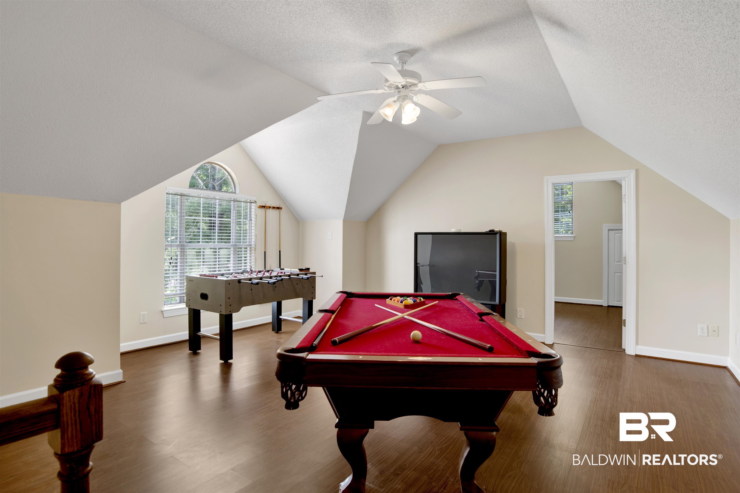 8847 Dawes Lake Road South Mobile, AL 36619 - Photo 28 of 47 Spacious bonus room featuring wood-finish flooring, a vaulted ceiling, and an arched transom window