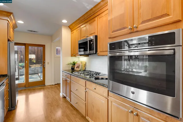 a kitchen with sink a window and potted plant