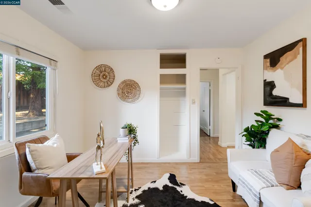 a living room with furniture potted plant and a window