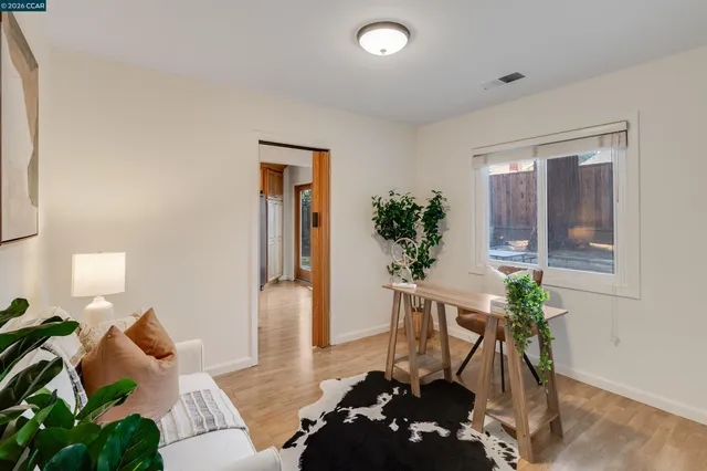 a view of a room with wooden floor lounge chair and windows