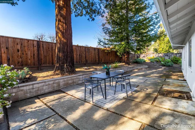 a view of a patio with table and chairs and potted plants