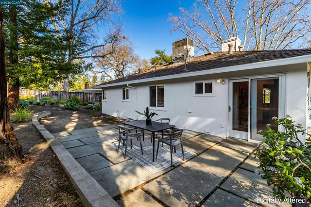 a view of a backyard with a tree