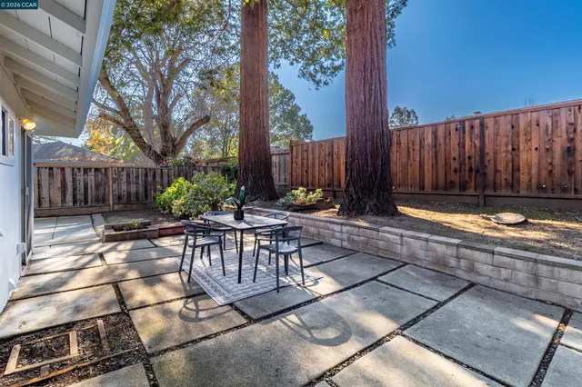 a view of a house with backyard and sitting area