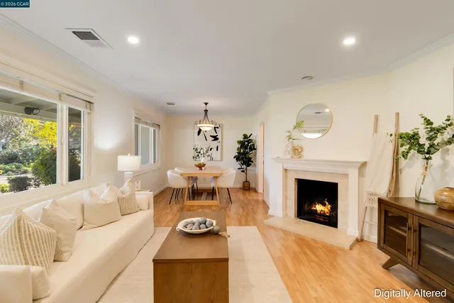 a living room with furniture a fireplace and a table