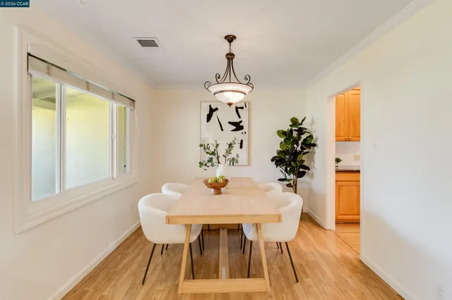 a view of a dining room with furniture wooden floor and a chandelier