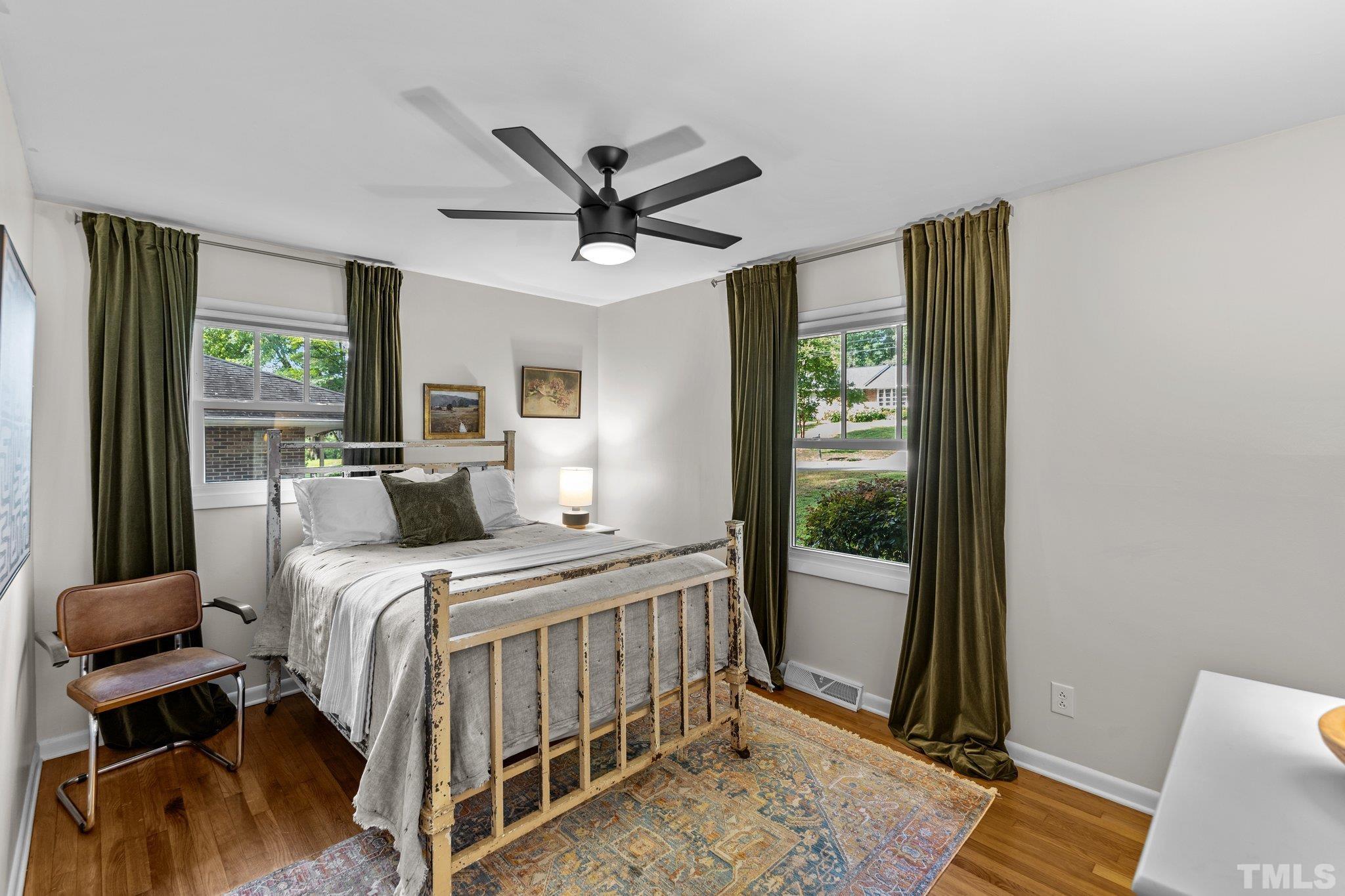 4912 Latimer Road Raleigh, NC 27609 - Photo 23 of 35 a bedroom with a bed and large windows