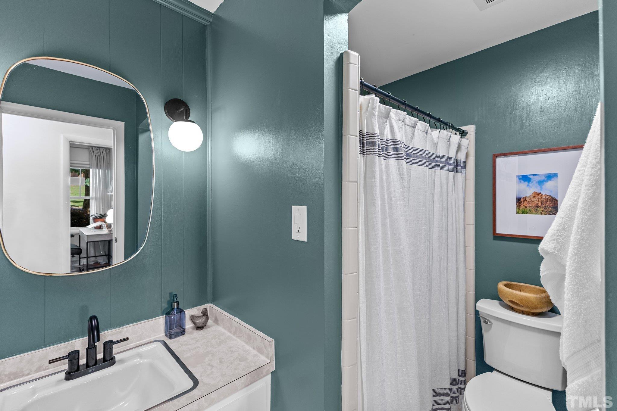4912 Latimer Road Raleigh, NC 27609 - Photo 25 of 35 a bathroom with a sink mirror and toilet