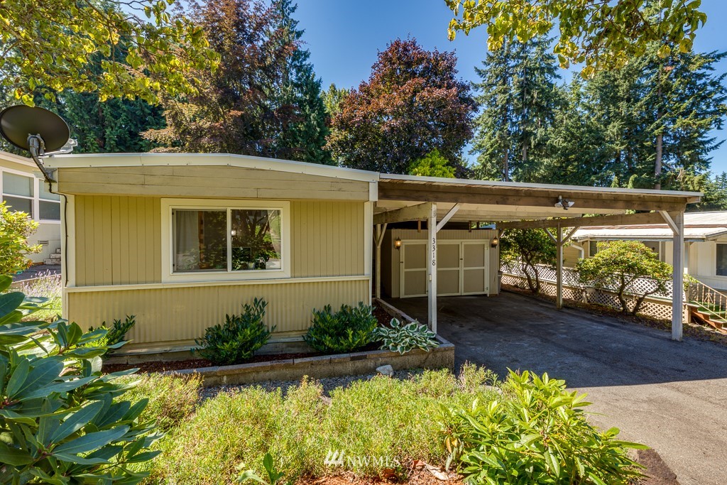 3318 206th Place Southeast Bothell, WA 98012 - Photo 1 of 35 a view of a house with a small yard plants and large tree